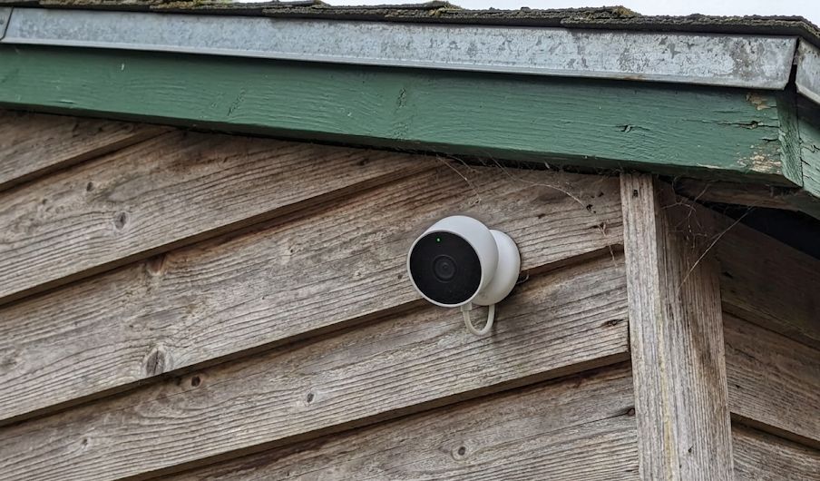 Google Nest Cam mounted on exterior wall under eave