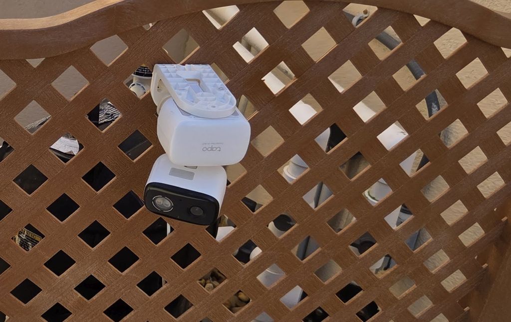 Security camera mounted on a wood fence